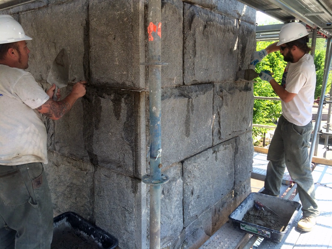 Two men working to repoint the Vance Monument in Downtown Asheville, NC